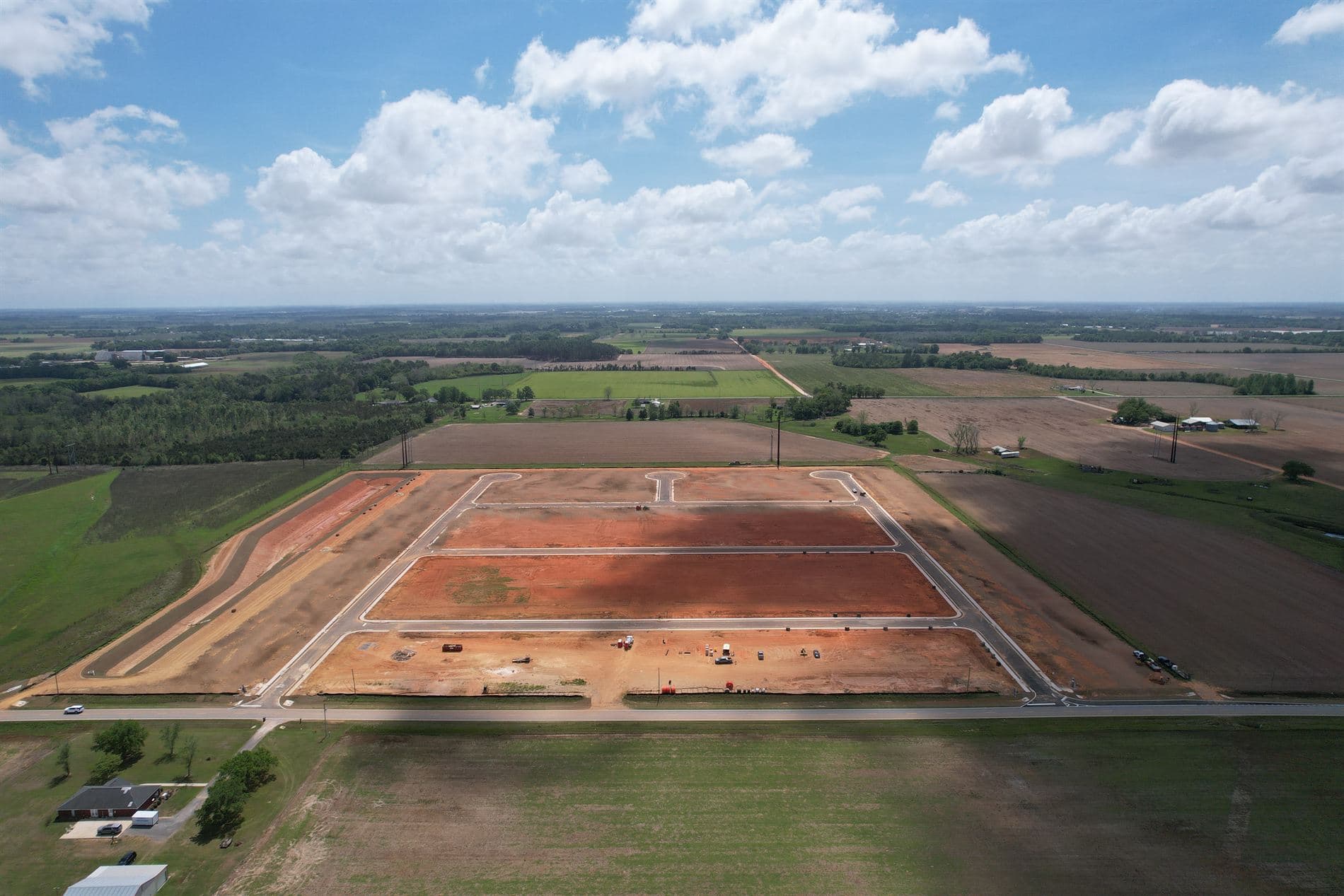 Aerial view of farmland transitioning into a platted residential subdivision