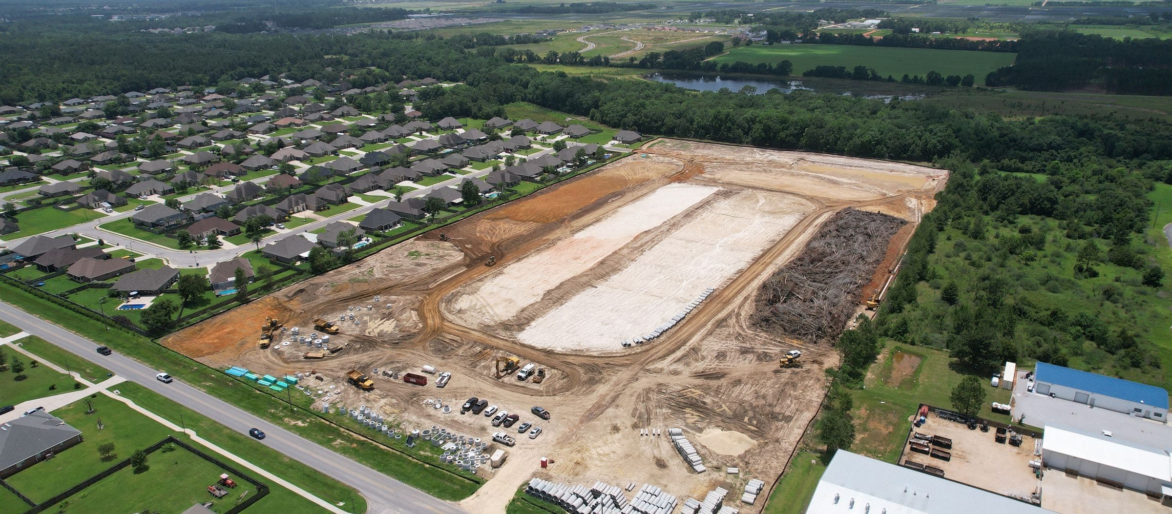 Aerial view of an established single-family neighborhood beside the next phase of graded lots